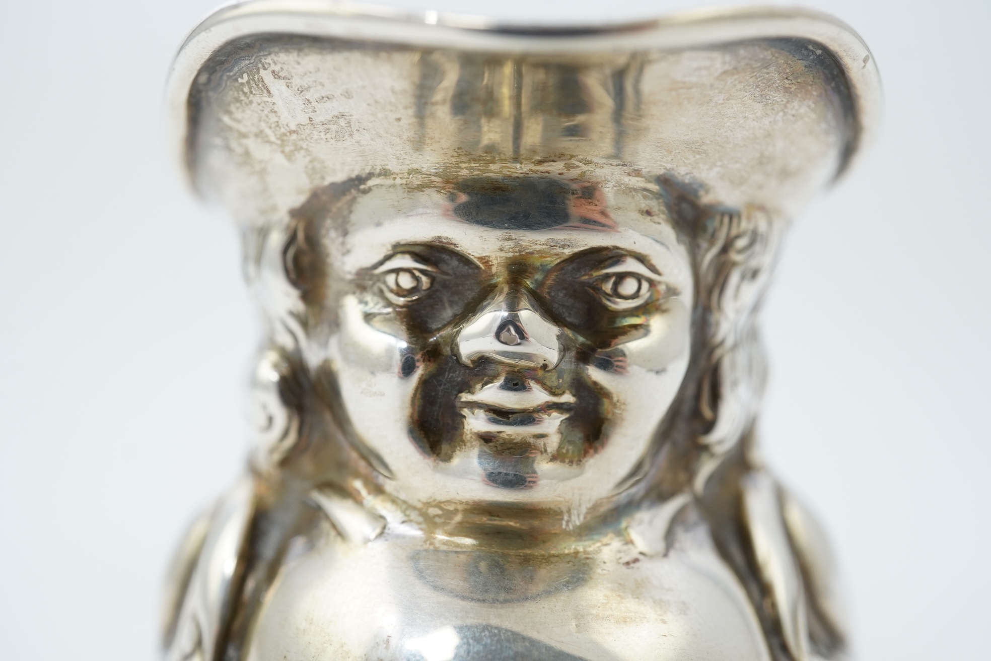 A George V novelty silver cream jug, modelled as a Toby Jug, by Hayes & Co
